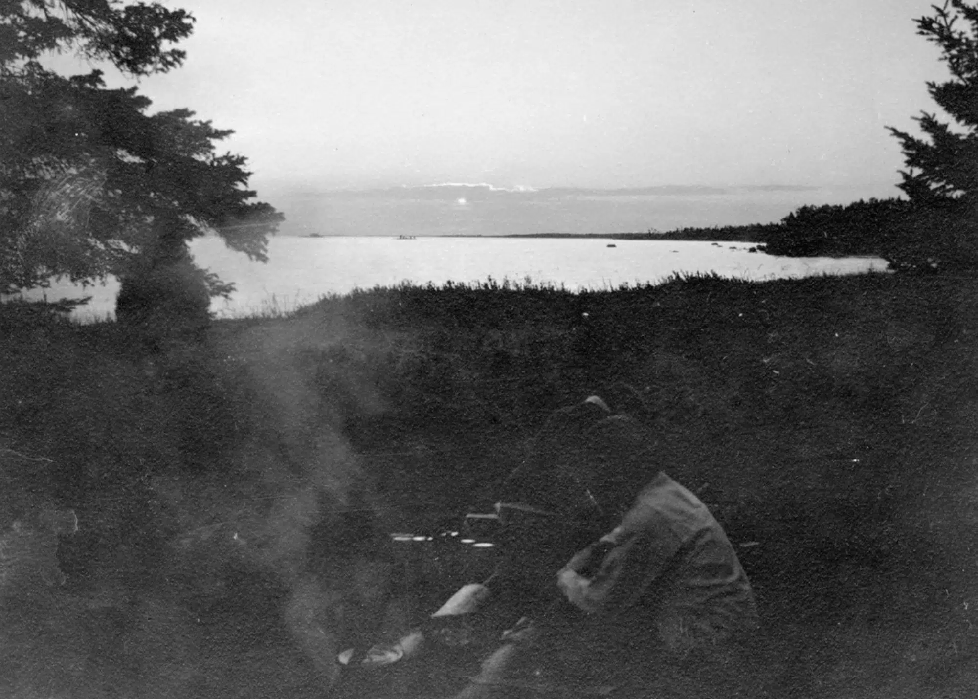 Women at campfire in Les Cheneaux, ca. 1900-09, part of Leopold family collection.