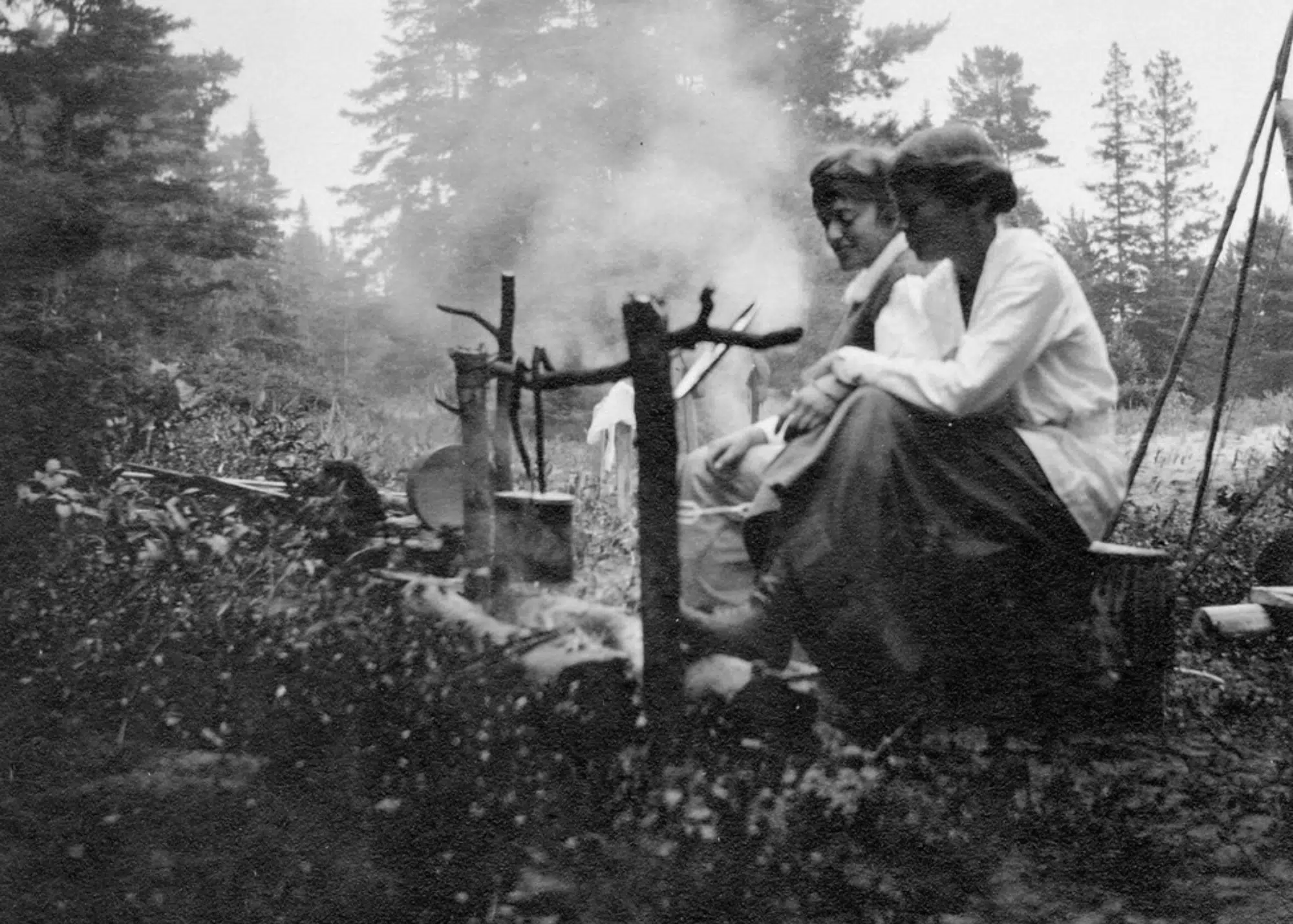 Women at campfire in Les Cheneaux, ca. 1900-09, part of Leopold family collection.