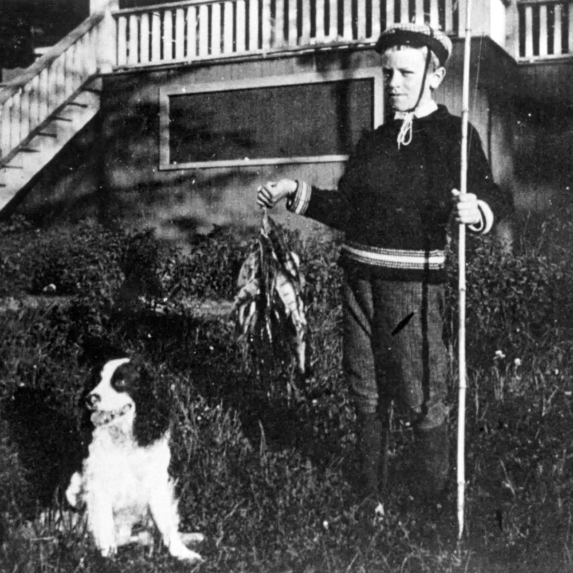 Young Aldo Leopold and his dog Spud display a stringer of fish in Les Cheneaux, ca. 1890-99.