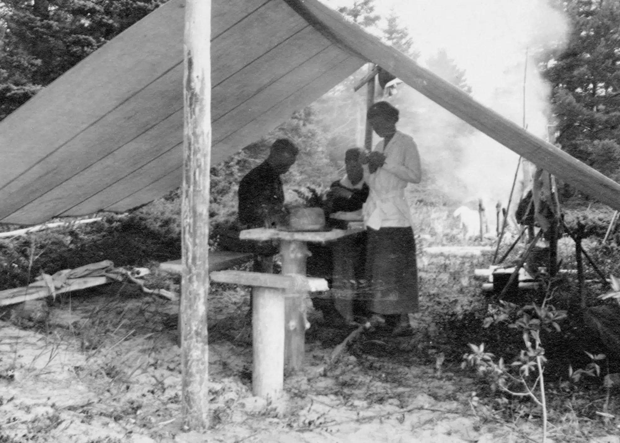Group camping under tent at Les Cheneaux, believed to be Leopold family relatives, ca. 1909-19.